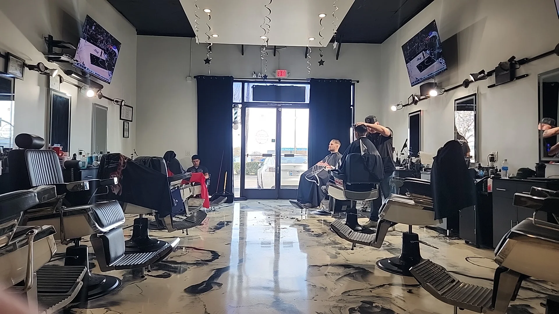 Barbers at work by the front door of PrecisionZ
